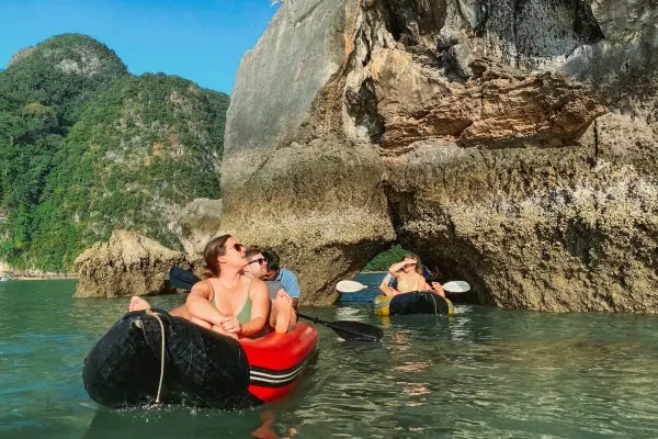 Guests canoeing beside limestone cliffs at Panak Island during the James Bond Island Sunset Plankton Tour