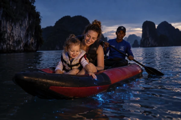Mother and daughter seeing bioluminescent plankton while canoeing in Phang Nga Bay at night