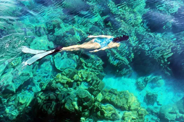 Snorkeling in clear water during the James Bond Island snorkeling tour from Phuket