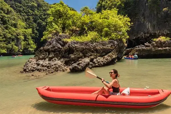 Guest canoeing through a limestone lagoon at Hong Island during the James Bond Island tour from Phuket