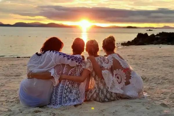 Phi Phi Island sunset tour from Phuket with travelers watching the sunset on the beach