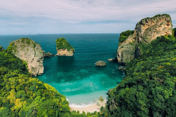 Aerial view of turquoise water, white sand beach and limestone cliffs in the Phi Phi Islands