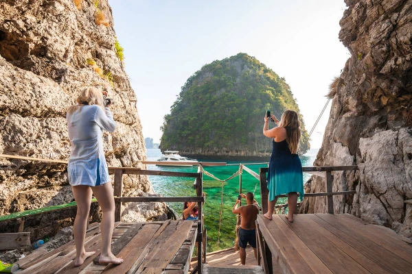 Travelers photographing limestone island scenery during the Phi Phi Island Sunrise Tour from Phuket
