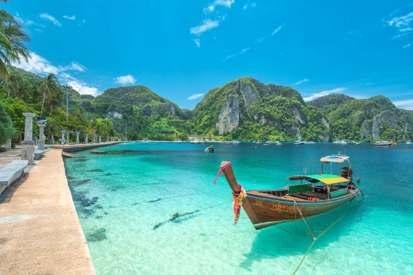 Traditional long-tail boat in clear turquoise water at the Phi Phi Islands