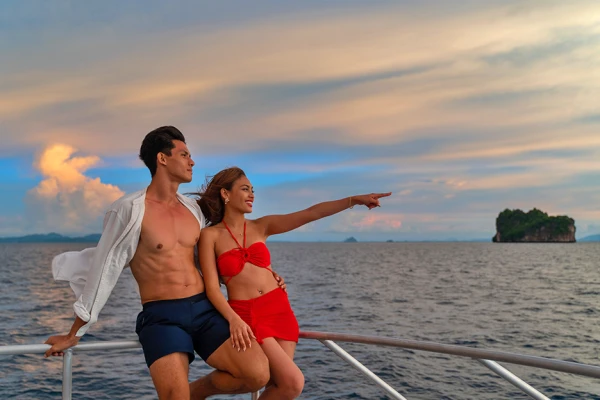 Couple enjoying an evening cruise near Maiton Island on the Phi Phi Luxury Speed Catamaran Tour from Phuket