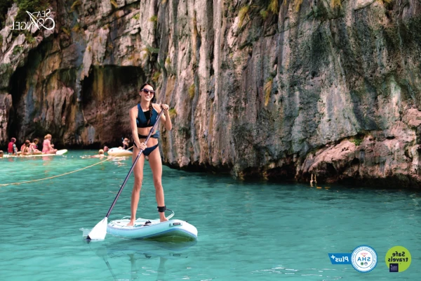 Stand-up paddleboarding in a turquoise lagoon during the Phi Phi Island speedboat tour from Phuket