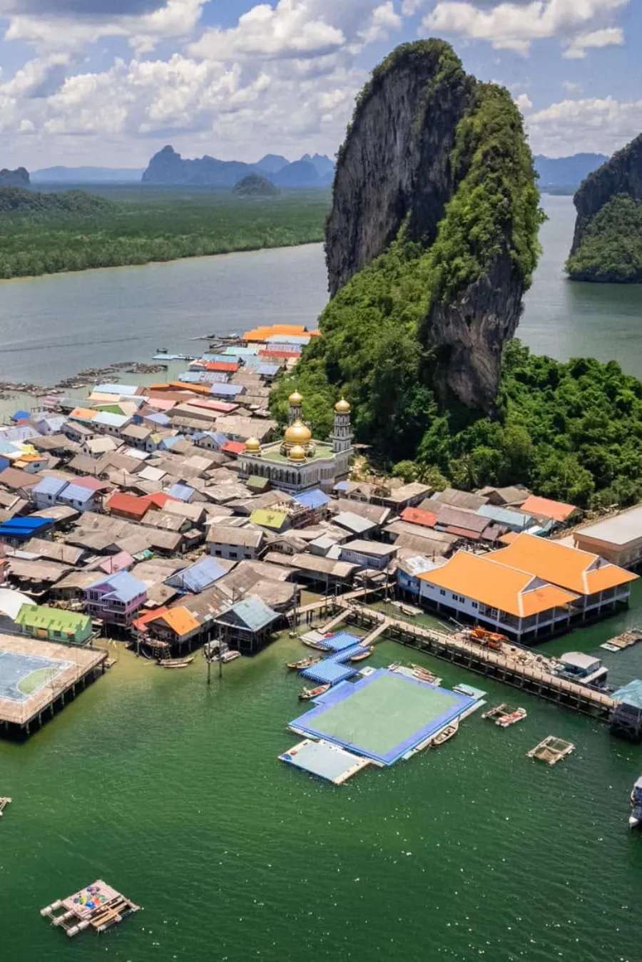 Aerial view of Koh Panyee fishing village, mosque and towering limestone cliffs in Phang Nga Bay, Thailand