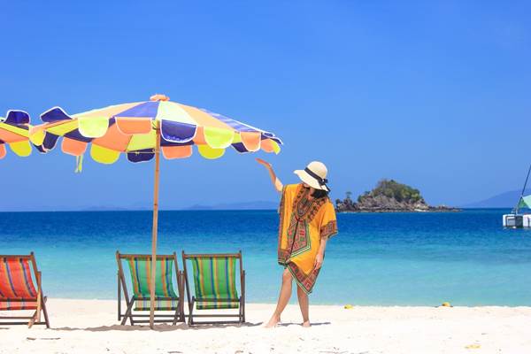 White sand tropical beach with colorful beach chairs during an island tour from Phuket